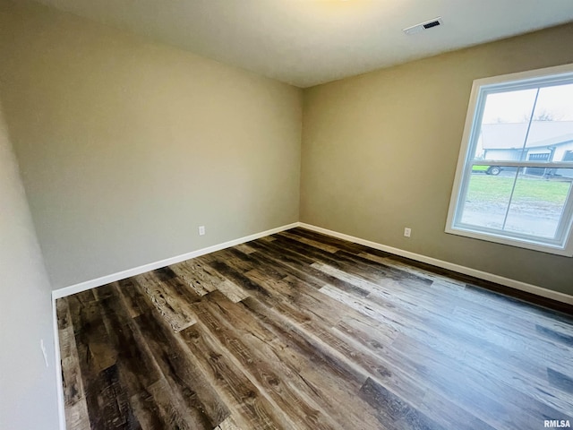 spare room featuring dark hardwood / wood-style floors