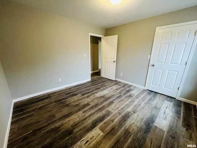 unfurnished bedroom featuring dark hardwood / wood-style flooring