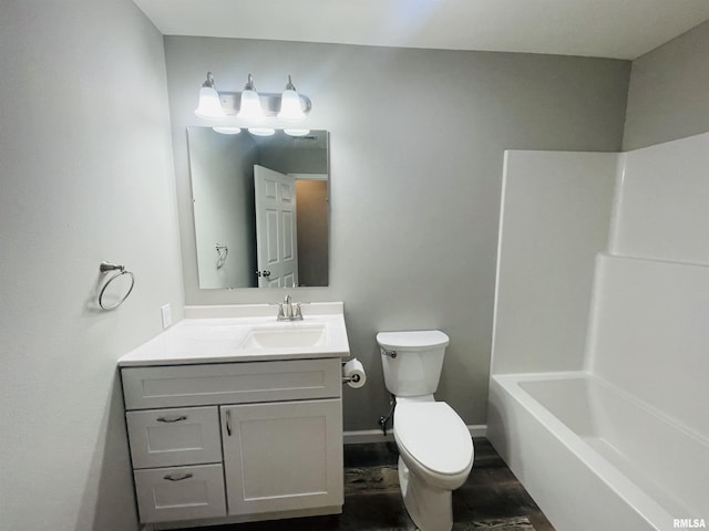 full bath with baseboards, vanity, and toilet