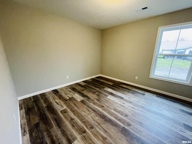 unfurnished bedroom with ceiling fan, dark hardwood / wood-style floors, and ensuite bathroom