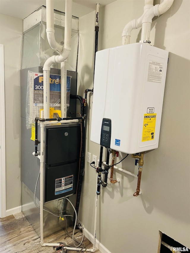 utility room featuring tankless water heater