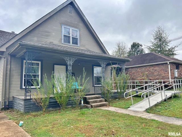 view of front of house featuring a front lawn and covered porch