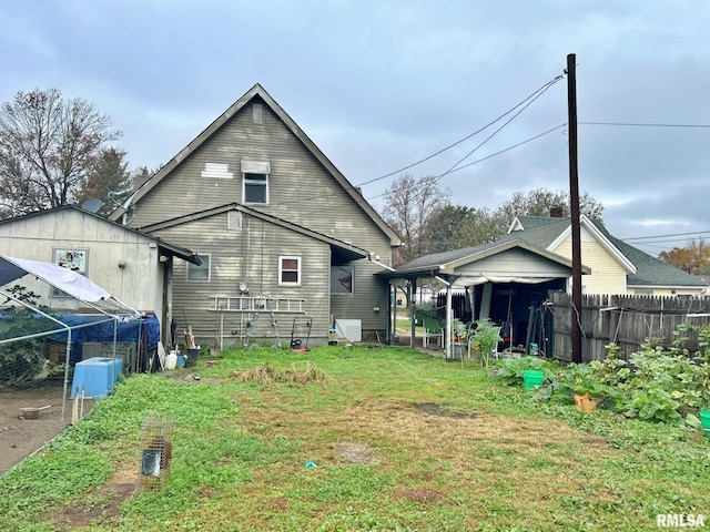 back of property with a lawn