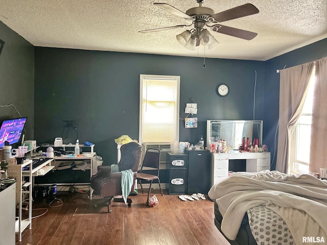 bedroom featuring a textured ceiling, hardwood / wood-style floors, and ceiling fan