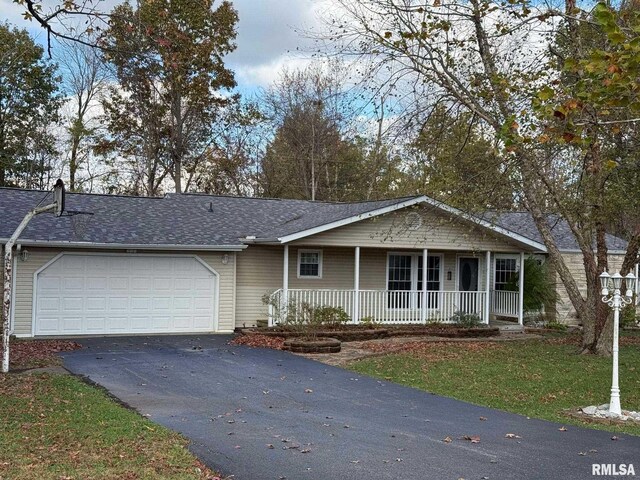 ranch-style home featuring a garage and a porch