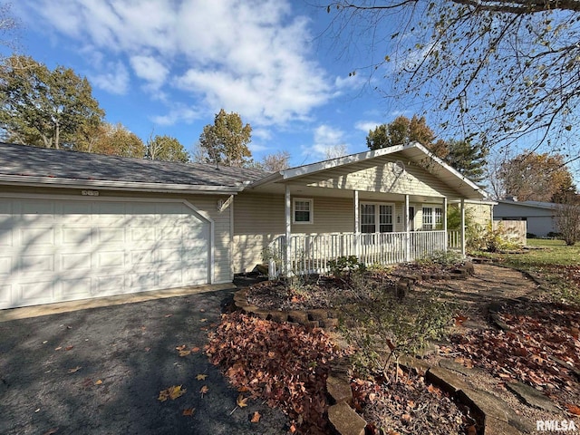 ranch-style house with a garage and covered porch