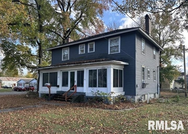 view of front of house featuring a sunroom