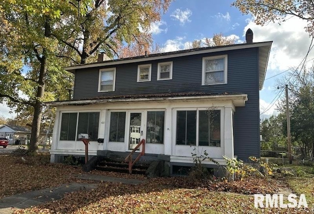 view of front of property with a sunroom