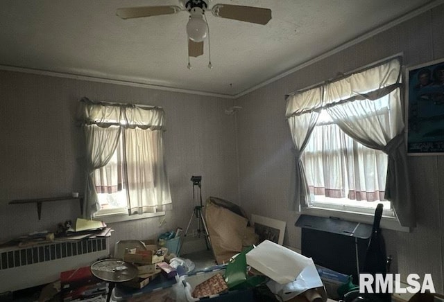 miscellaneous room with ceiling fan, plenty of natural light, radiator heating unit, and ornamental molding