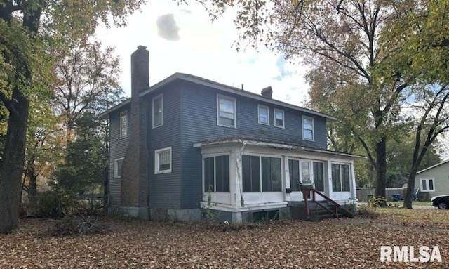 view of front of home featuring a sunroom