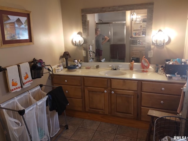 bathroom with vanity, tile patterned floors, and a shower with door