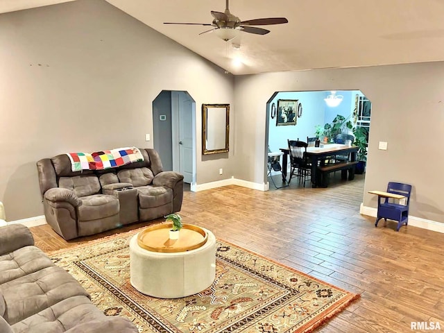 living room featuring ceiling fan, hardwood / wood-style floors, and lofted ceiling