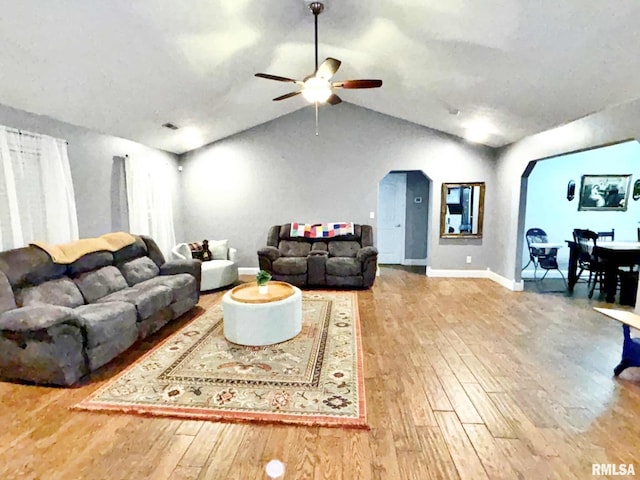 living room featuring ceiling fan, wood-type flooring, and lofted ceiling