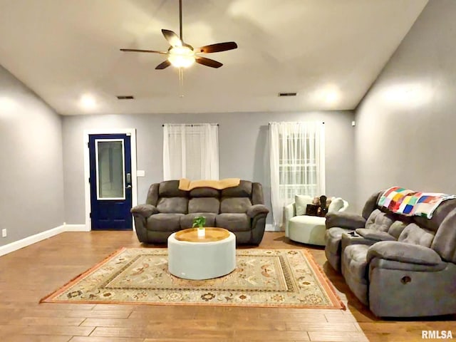 living room featuring ceiling fan and light hardwood / wood-style flooring