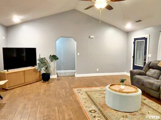 living room with light wood-type flooring, ceiling fan, and lofted ceiling