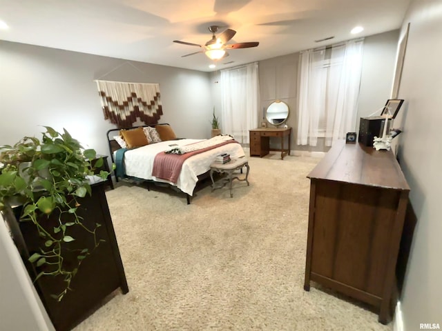 bedroom with ceiling fan and light colored carpet