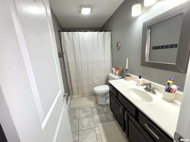 bathroom with vanity, toilet, and walk in shower