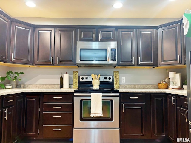 kitchen featuring dark brown cabinets and stainless steel appliances