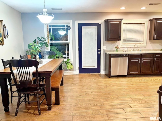 kitchen featuring dishwasher, dark brown cabinets, sink, and decorative light fixtures