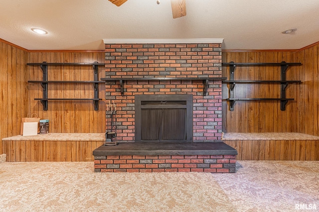 living room with wooden walls, a textured ceiling, and carpet floors