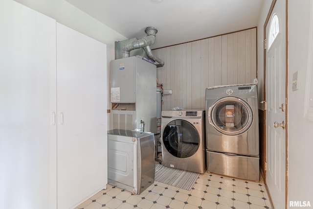 washroom featuring wooden walls and independent washer and dryer