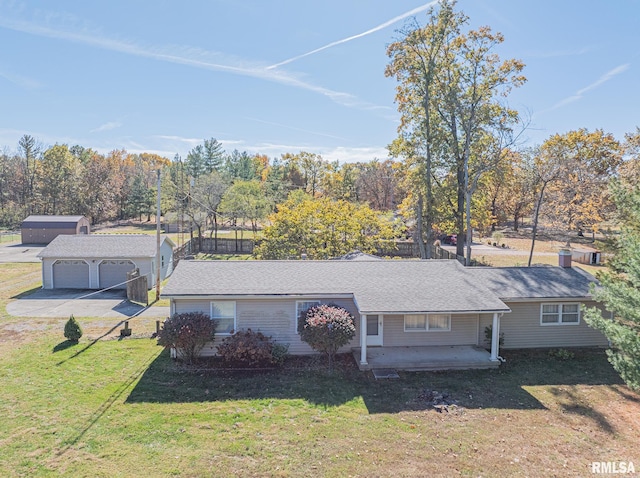 view of front of house with an outbuilding, a garage, and a front yard