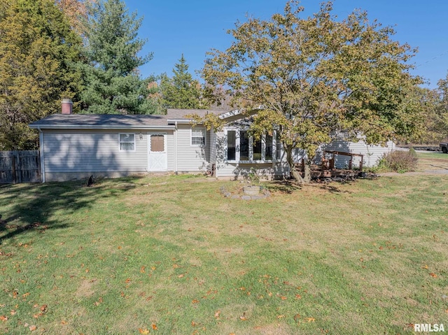 rear view of house with a yard