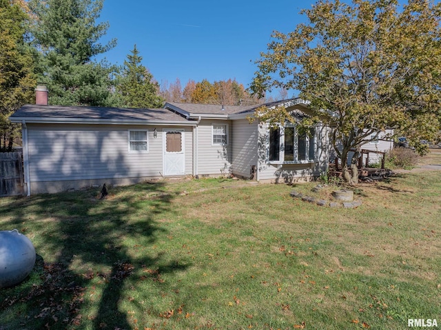 back of house with a lawn