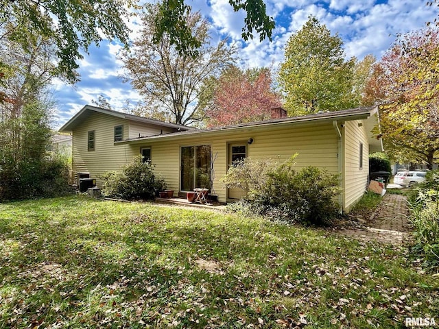 back of property featuring a lawn