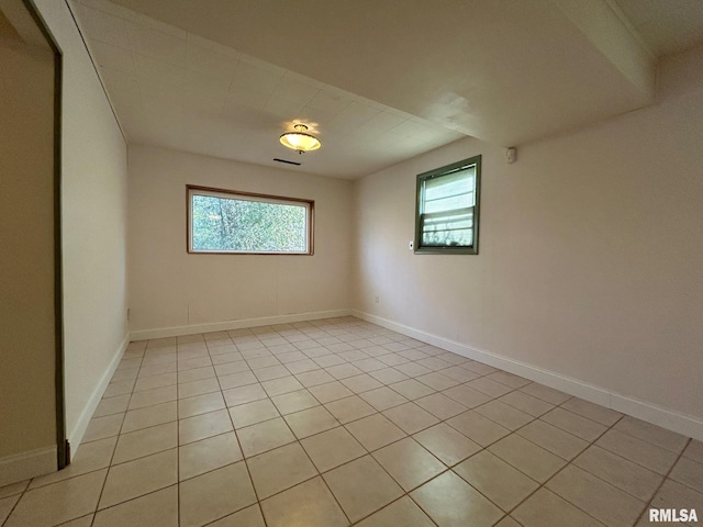 unfurnished room with light tile patterned floors