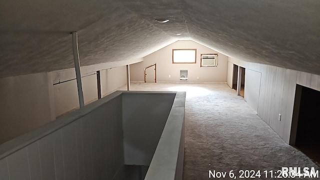 additional living space featuring vaulted ceiling and light colored carpet