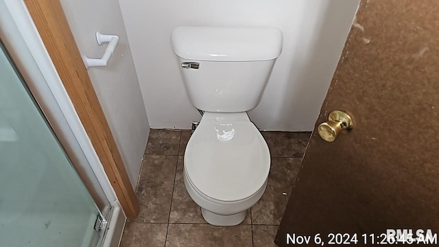 room details featuring tile patterned flooring and toilet