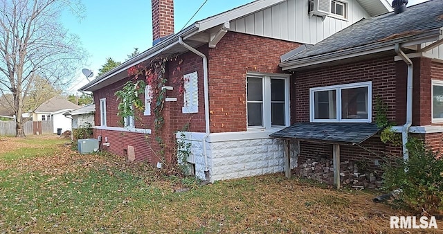 view of property exterior with central air condition unit, a lawn, and cooling unit