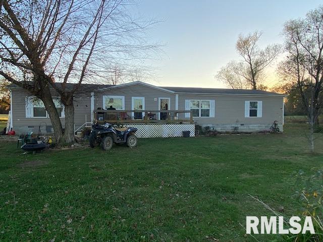 back house at dusk with a yard