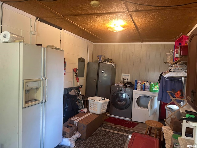 washroom with wood walls and independent washer and dryer