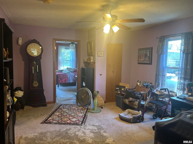 dining space featuring ceiling fan, a textured ceiling, and carpet floors