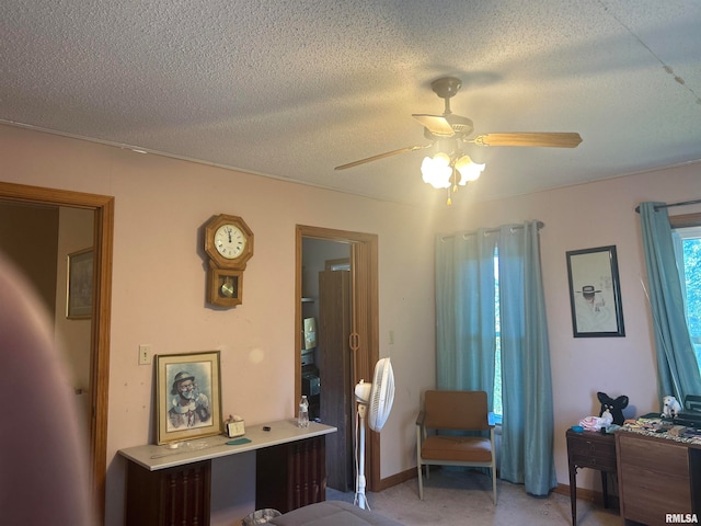 bedroom with a textured ceiling and ceiling fan