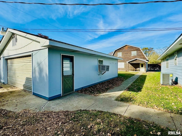 view of home's exterior with cooling unit, a yard, and central air condition unit