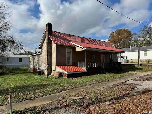 exterior space with a front lawn and a wooden deck