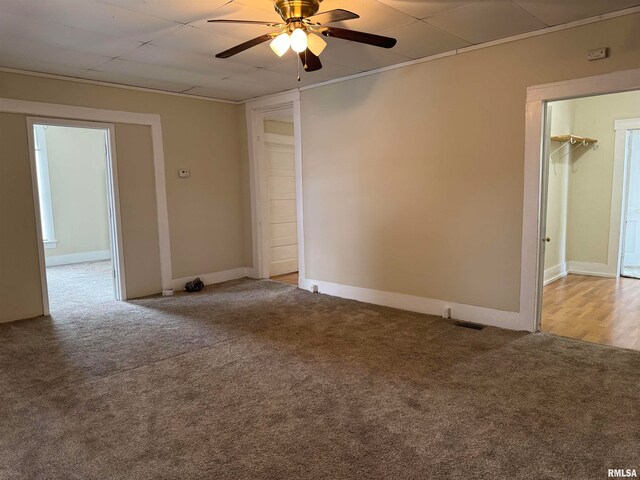 spare room with light colored carpet and ceiling fan