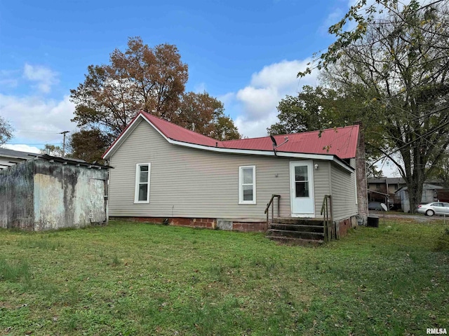 back of house with a yard