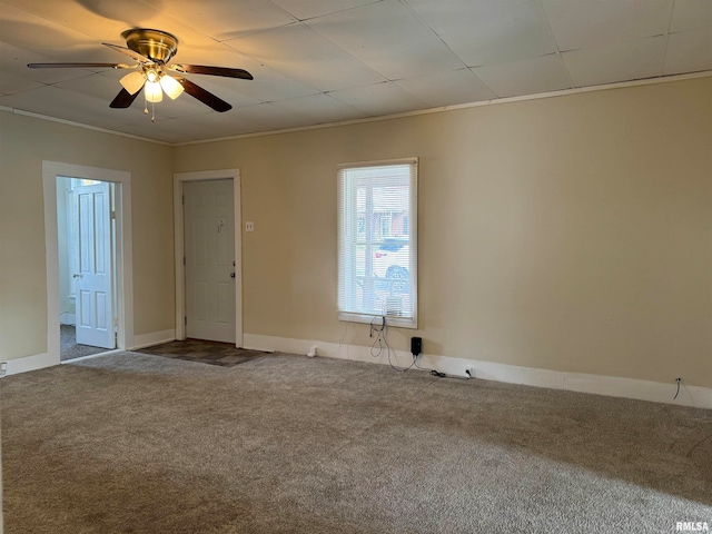 carpeted empty room featuring ceiling fan and crown molding