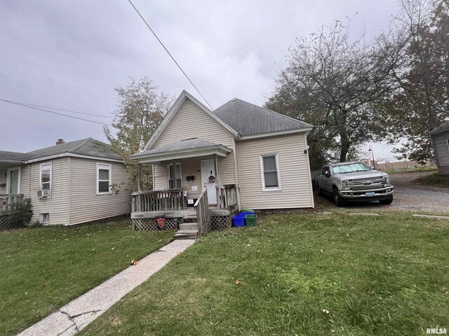 416 S Washington St, Carbondale, IL 62901 - view of front facade featuring covered porch, a front lawn, a shingled roof, and cooling unit