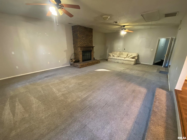 unfurnished living room featuring a brick fireplace, ceiling fan, and dark colored carpet