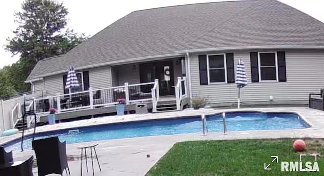 view of swimming pool with a deck and a patio