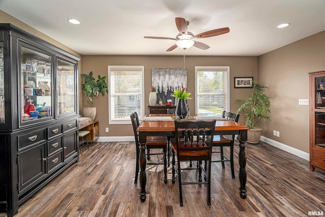 dining area featuring ceiling fan and dark hardwood / wood-style flooring