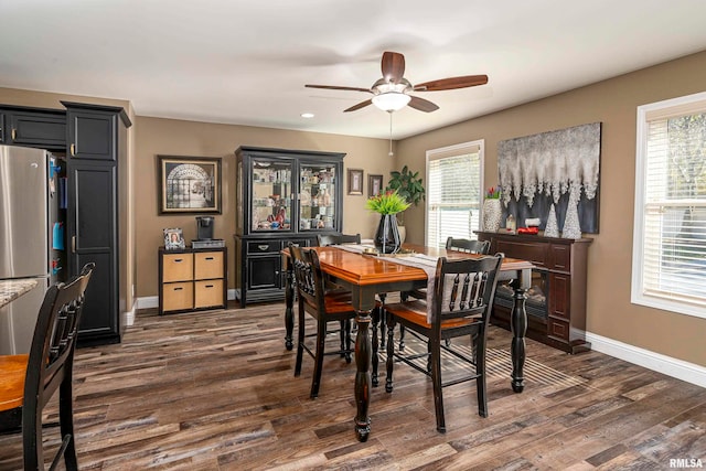 dining space with ceiling fan, dark hardwood / wood-style flooring, and a healthy amount of sunlight