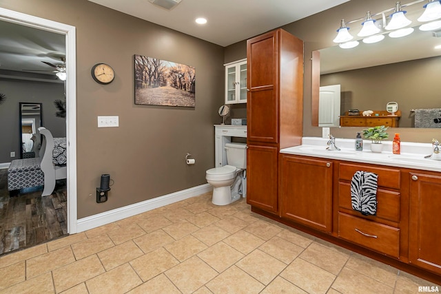 bathroom with vanity, ceiling fan, toilet, and wood-type flooring