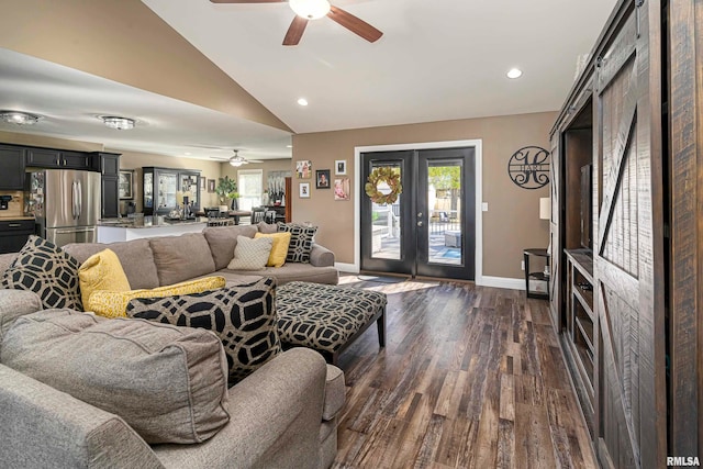 living room featuring ceiling fan, french doors, a healthy amount of sunlight, and dark hardwood / wood-style floors