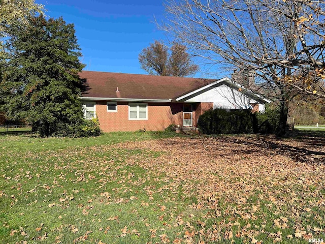 view of side of home featuring a lawn